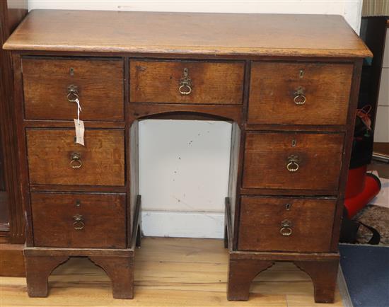 A George III oak kneehole desk W.95cm